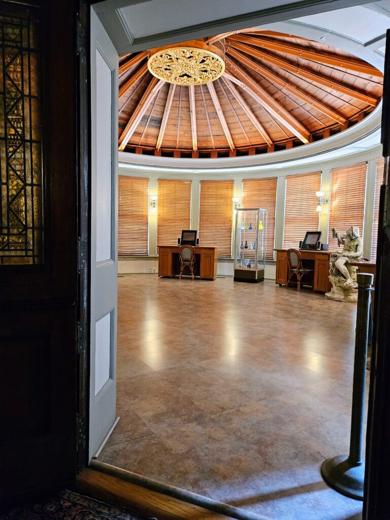 Open doorway showing a round room with a wooden dome ceiling.