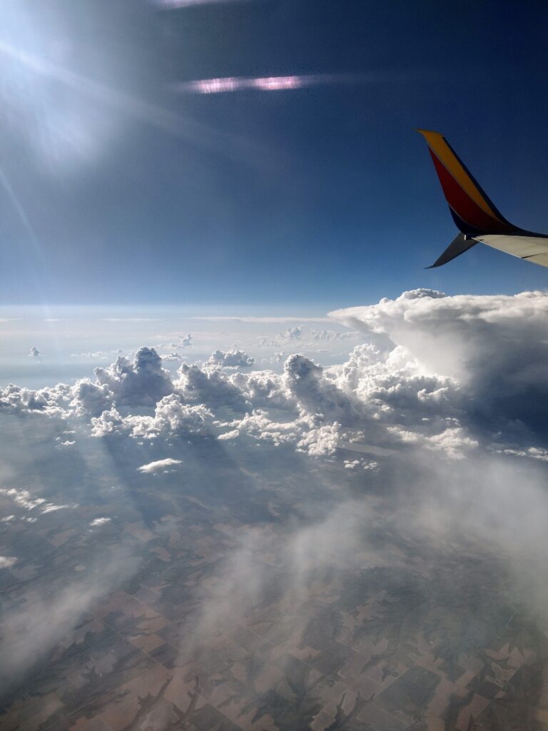 A mushroom cloud with the sun beaming on it.
